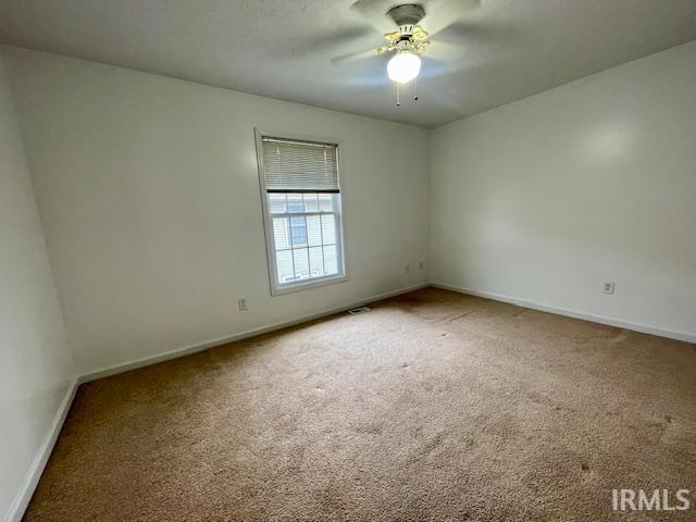 spare room with ceiling fan and carpet floors