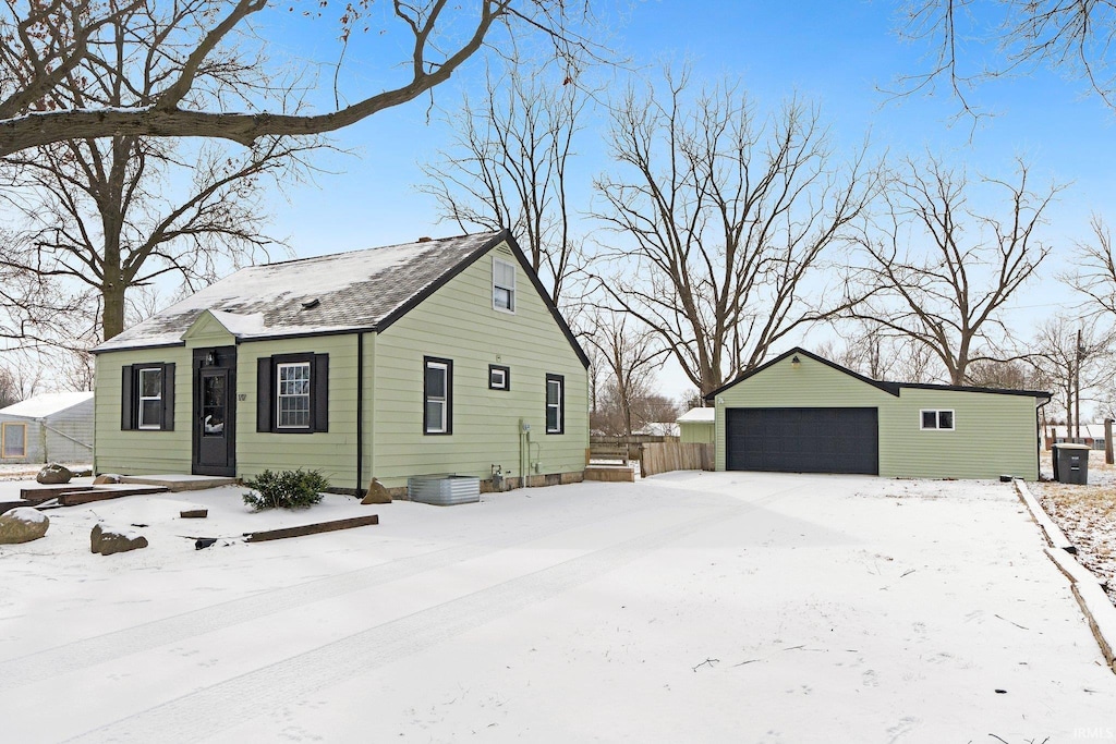 view of snow covered exterior featuring a garage