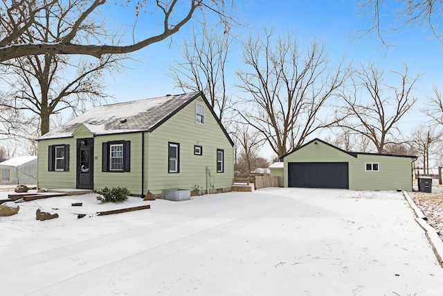 view of snow covered exterior featuring a garage