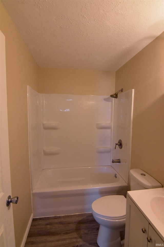 full bathroom featuring toilet, shower / bathtub combination, a textured ceiling, vanity, and hardwood / wood-style floors