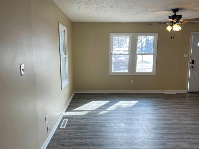 foyer featuring ceiling fan, dark wood-type flooring, and a textured ceiling