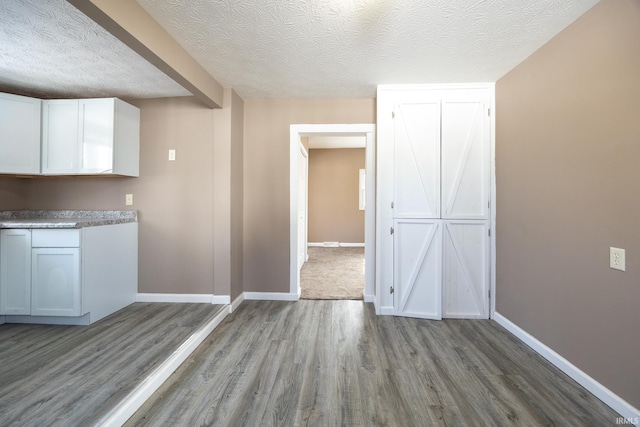 interior space featuring light hardwood / wood-style flooring and a textured ceiling