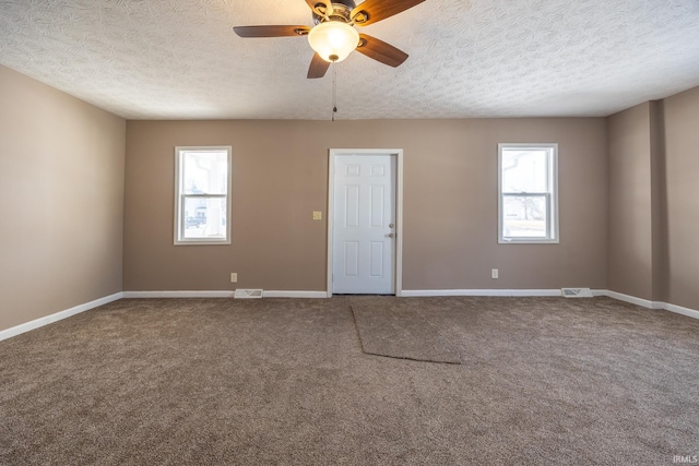 unfurnished room featuring carpet floors, a textured ceiling, and ceiling fan