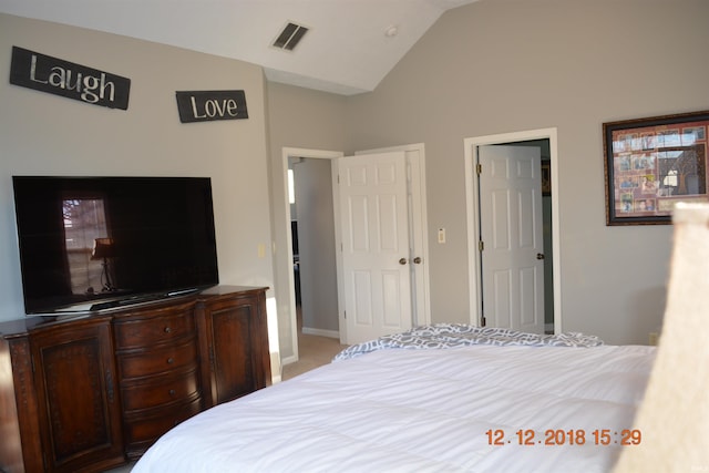 bedroom with lofted ceiling, baseboards, and visible vents