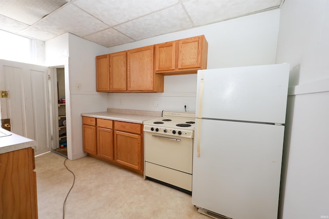 kitchen with white appliances and a paneled ceiling