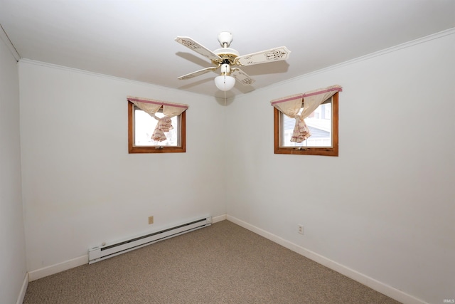 carpeted empty room featuring a baseboard heating unit, ceiling fan, crown molding, and plenty of natural light