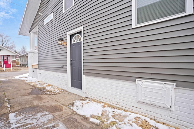 view of snow covered property entrance