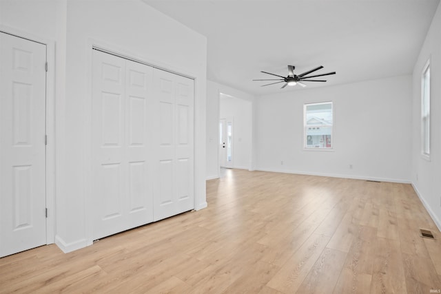 unfurnished living room featuring ceiling fan and light hardwood / wood-style flooring