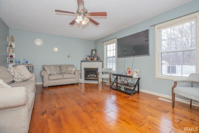 living room featuring hardwood / wood-style flooring and ceiling fan