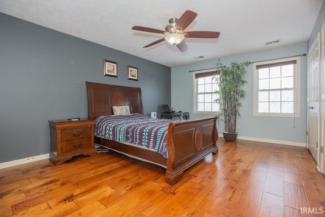 bedroom with ceiling fan and light hardwood / wood-style flooring