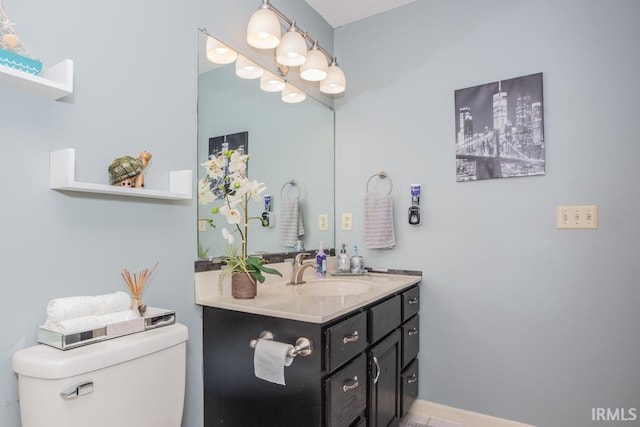 bathroom featuring toilet and vanity