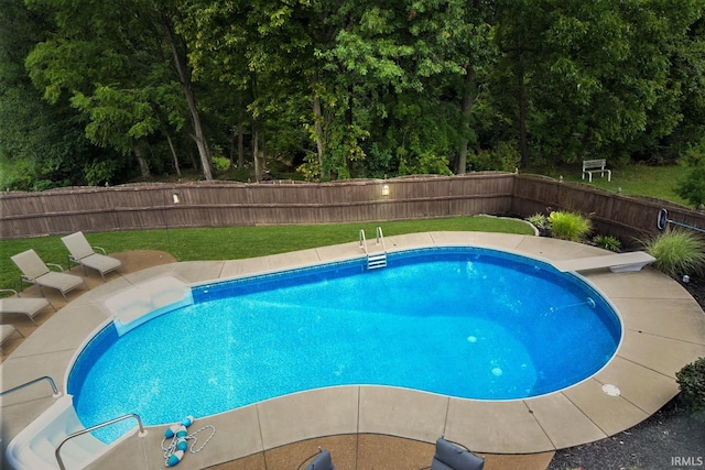 view of pool featuring a diving board