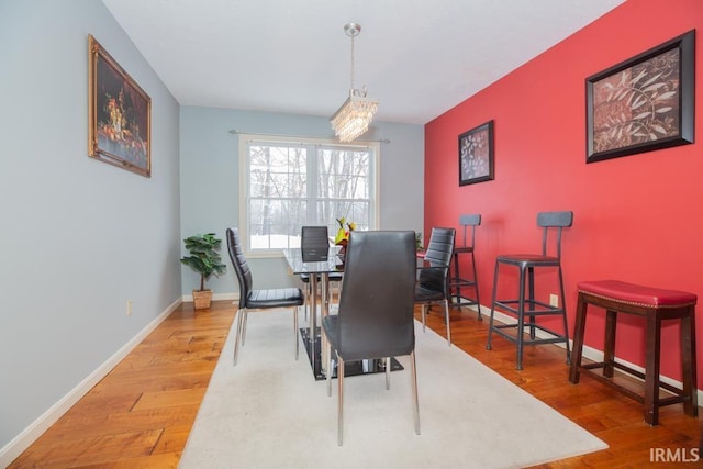 dining room featuring hardwood / wood-style floors and an inviting chandelier