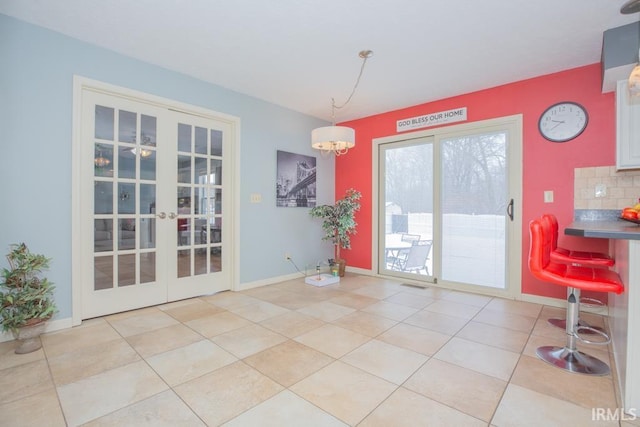 dining space featuring light tile patterned floors and french doors