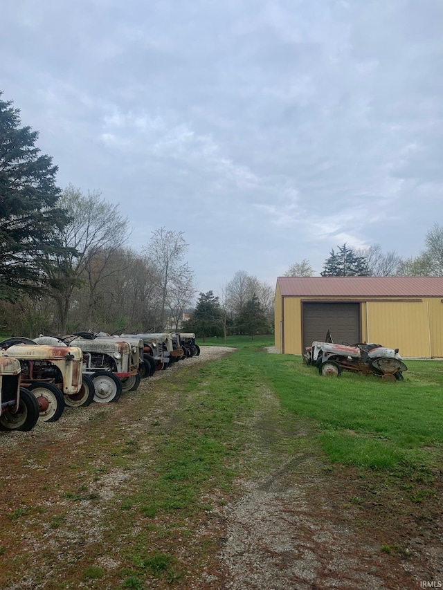 exterior space featuring a garage and a yard