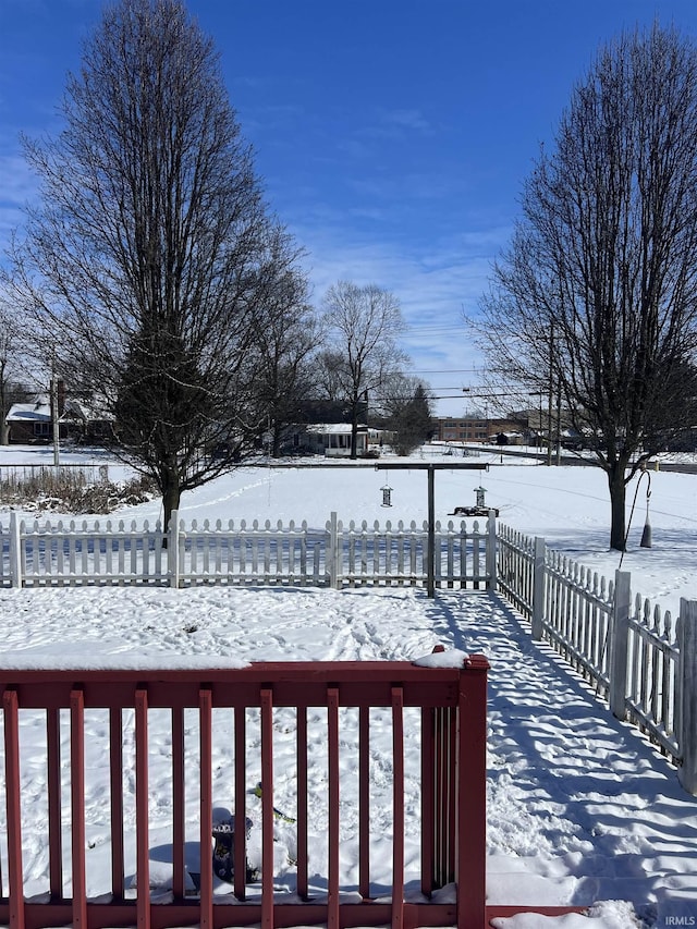 snow covered deck with fence