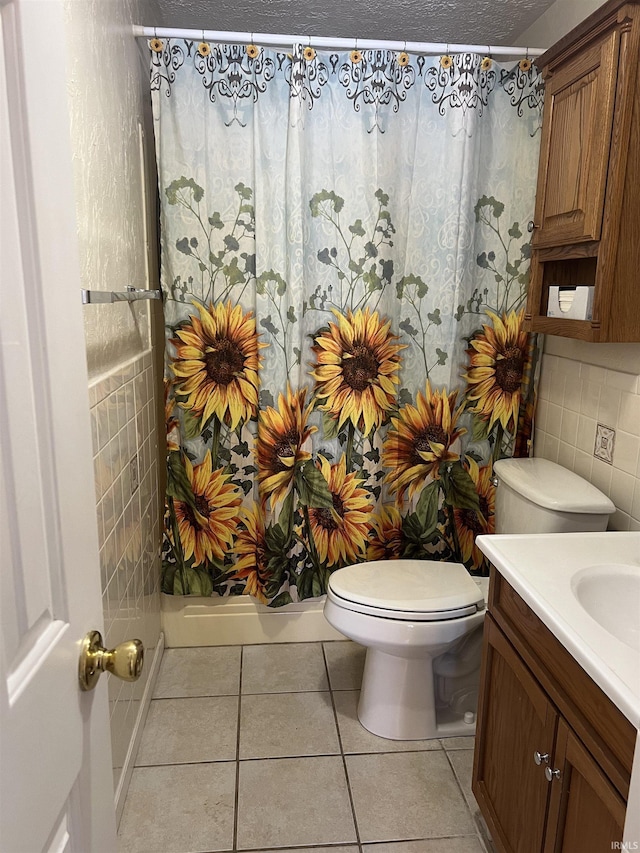 bathroom featuring curtained shower, toilet, tile patterned floors, vanity, and decorative backsplash