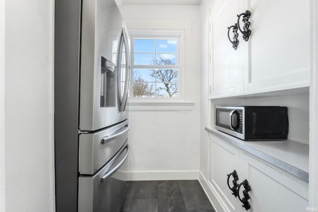 kitchen featuring appliances with stainless steel finishes, white cabinets, and wood-type flooring