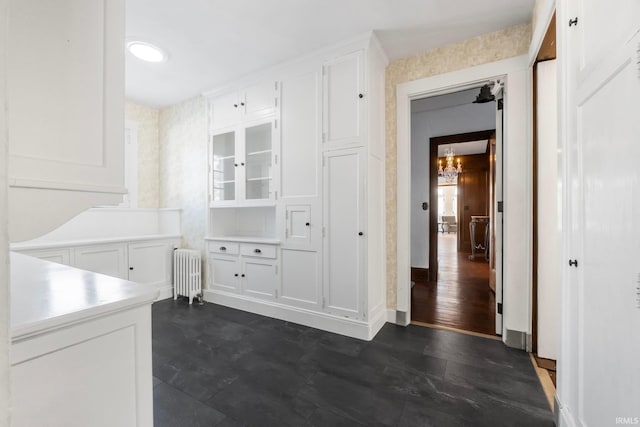 interior space featuring radiator and white cabinets