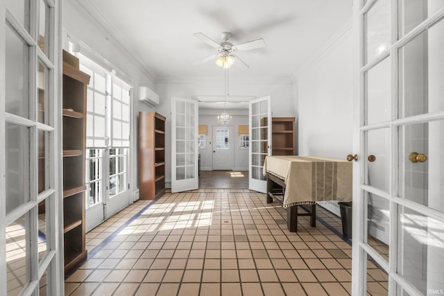 interior space with ceiling fan with notable chandelier, crown molding, an AC wall unit, and french doors