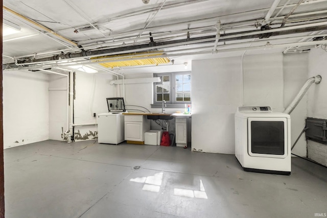 basement featuring sink and washer / clothes dryer