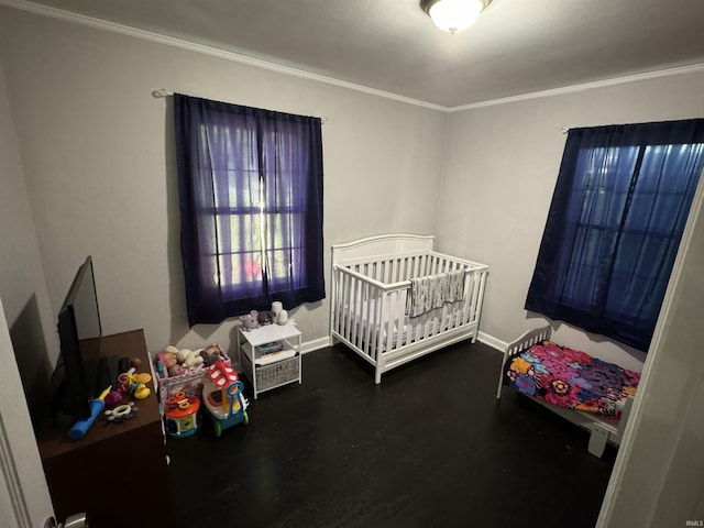 bedroom featuring ornamental molding and a nursery area