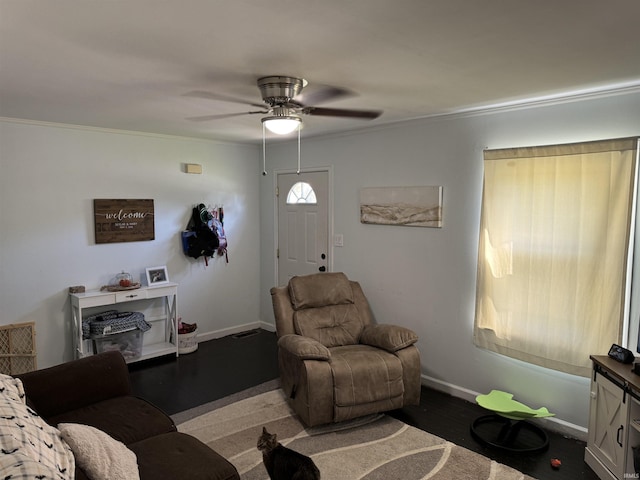 living room featuring hardwood / wood-style flooring, crown molding, and ceiling fan