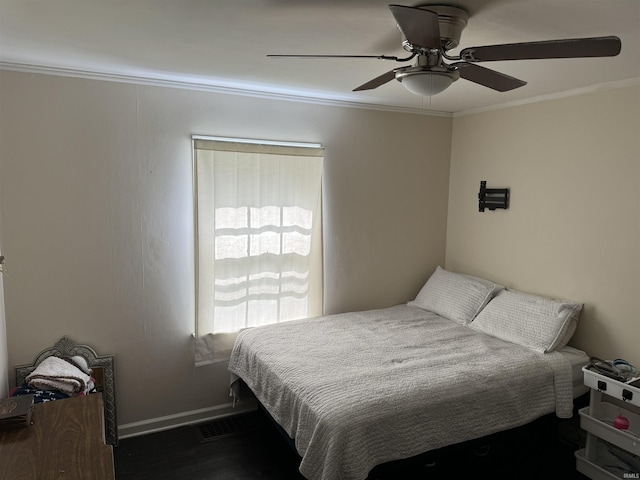 bedroom with ceiling fan, dark wood-type flooring, and ornamental molding