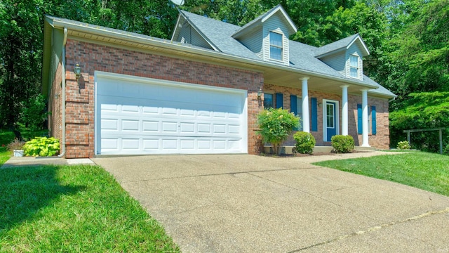 new england style home with brick siding, concrete driveway, a garage, and a front yard