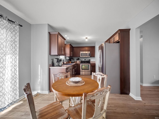 dining room featuring light hardwood / wood-style flooring and sink