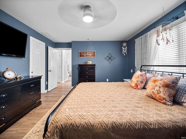 bedroom featuring ceiling fan and light hardwood / wood-style flooring