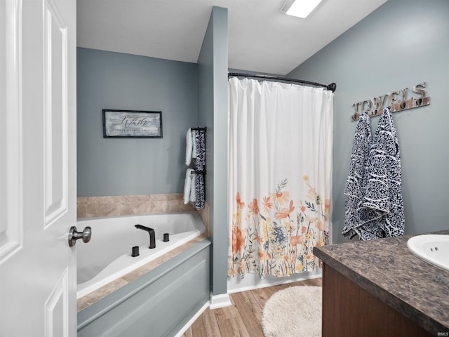 bathroom with vanity, a bathing tub, and hardwood / wood-style floors