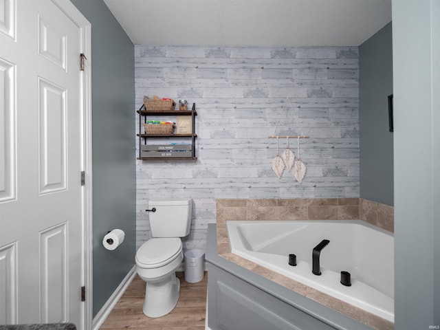 bathroom with hardwood / wood-style flooring, toilet, and a bathing tub