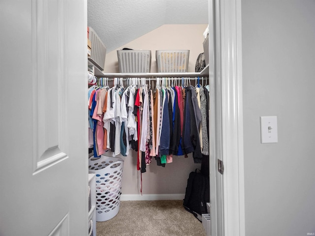 spacious closet with light carpet and lofted ceiling