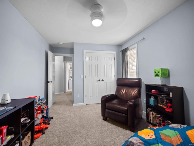 bedroom featuring light carpet, a closet, and ceiling fan