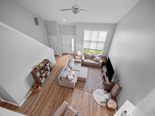 living room with ceiling fan and light hardwood / wood-style floors