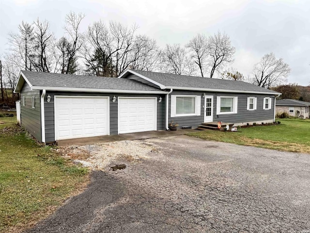 ranch-style home with a front yard and a garage