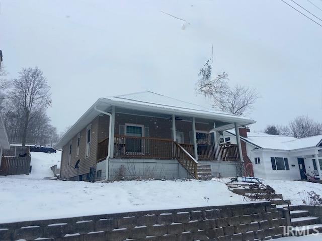 view of front of property with a porch and stairs