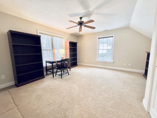 home office featuring ceiling fan, vaulted ceiling, carpet floors, and a textured ceiling