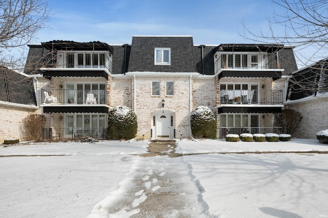 view of front of house featuring a balcony