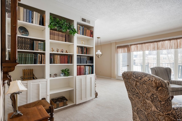 living area featuring ornamental molding, carpet, and a textured ceiling