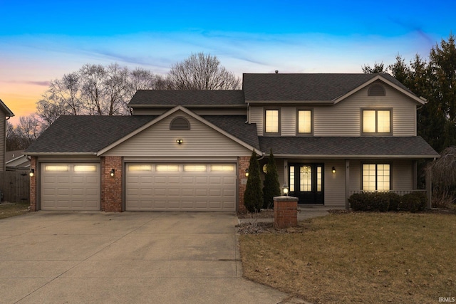 view of front property with a garage and a yard