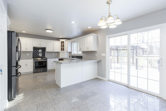 kitchen featuring white cabinetry, kitchen peninsula, stainless steel appliances, light stone counters, and pendant lighting