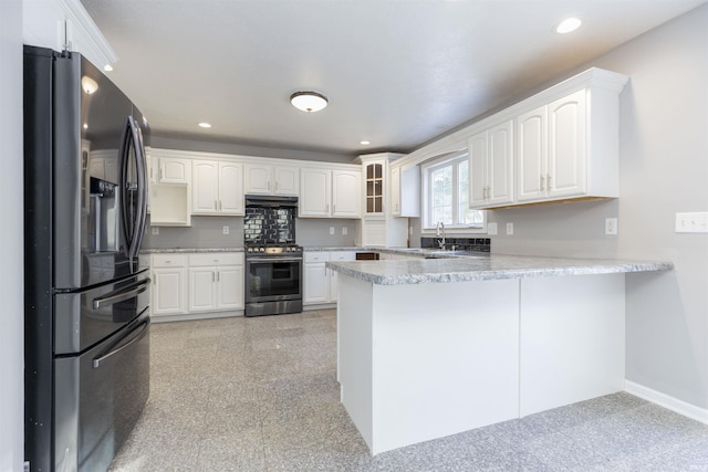 kitchen featuring stainless steel range with gas cooktop, white cabinetry, fridge with ice dispenser, and kitchen peninsula