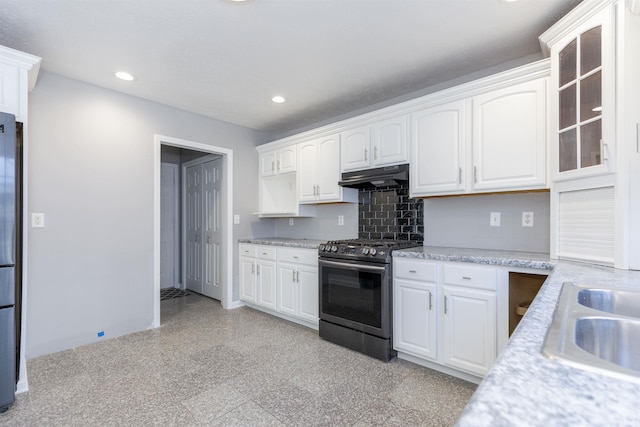 kitchen with sink, appliances with stainless steel finishes, white cabinets, and tasteful backsplash