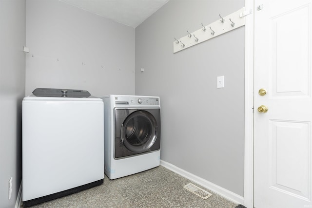 washroom with independent washer and dryer