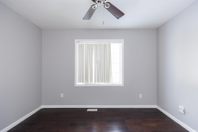 spare room featuring dark hardwood / wood-style flooring and ceiling fan