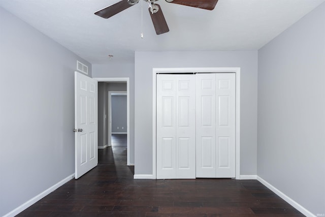 unfurnished bedroom with ceiling fan, a closet, and dark hardwood / wood-style flooring