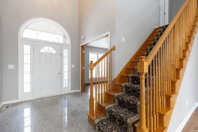 entryway with a towering ceiling