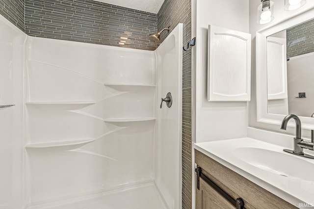 bathroom featuring vanity and a shower